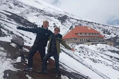 Two friends at José Rivas Refuge, adventure awaits on Cotopaxi volcano trails
